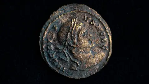 Tony Jolliffe BBC A close up of a Roman coin with detail found during HS2 archaeological excavations